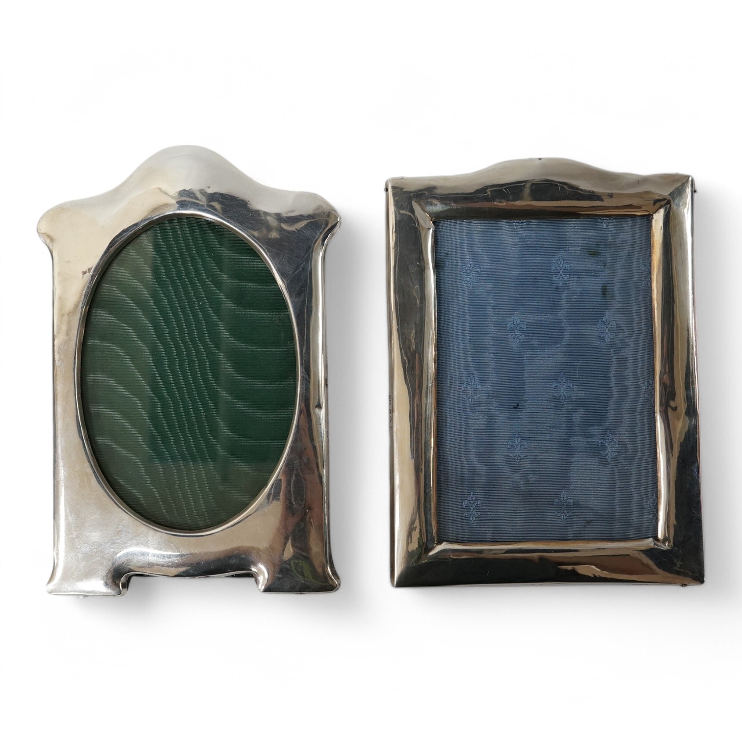 Two George V silver mounted photograph frames, makers differ, both Birmingham, 1912, largest 20cm. Condition - poor to fair